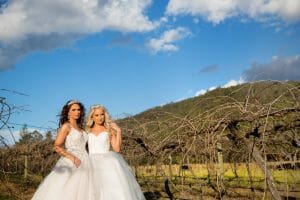gay couple bridal portraits in the grapevines at Stonehurst weddings